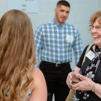 Guest smiling at a student's project